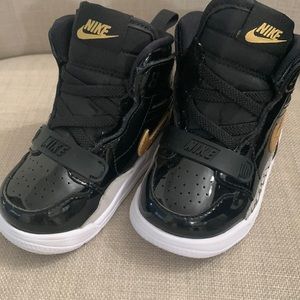 Toddler High top Nike black patent leather with gold Nike logo and white sole